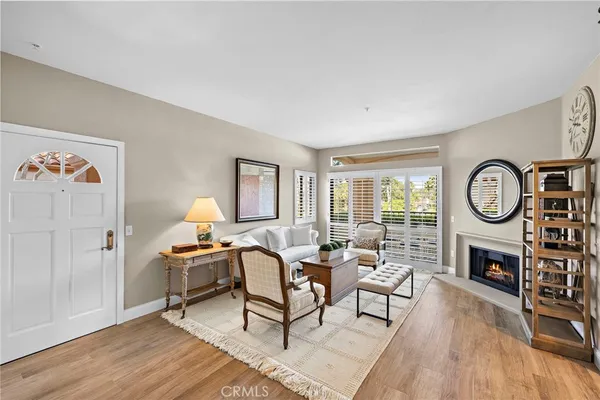 a living room with furniture a window and a fireplace