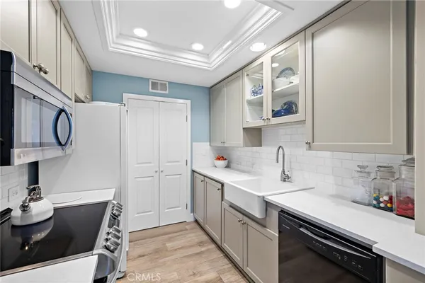 a kitchen with a sink cabinets and appliances