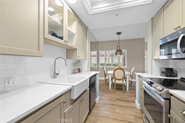 a kitchen with stainless steel appliances granite countertop a sink stove and cabinets