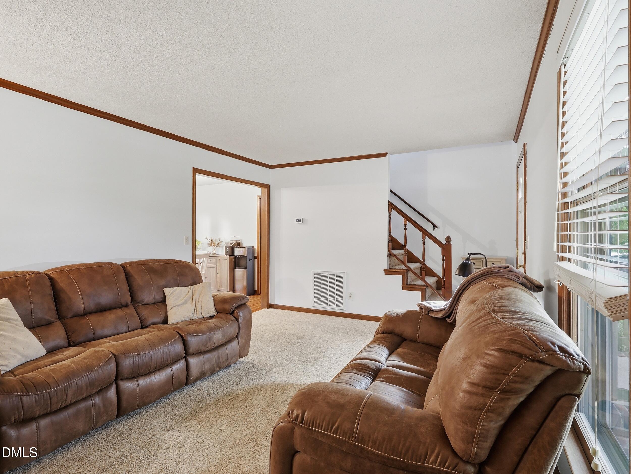 517 Lake Glad Road Wendell, NC 27591 - Photo 8 of 36 a living room with furniture and a flat screen tv