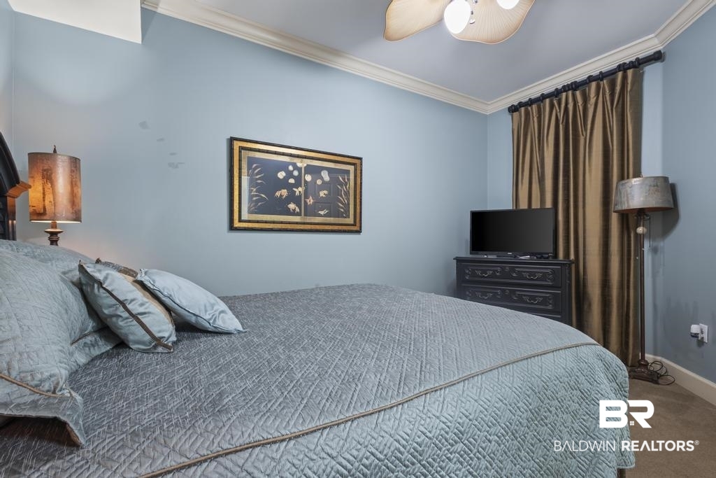 27582 Canal Road, Unit 2408 Orange Beach, AL 36561 - Photo 15 of 47 Carpeted bedroom with ornamental molding and ceiling fan