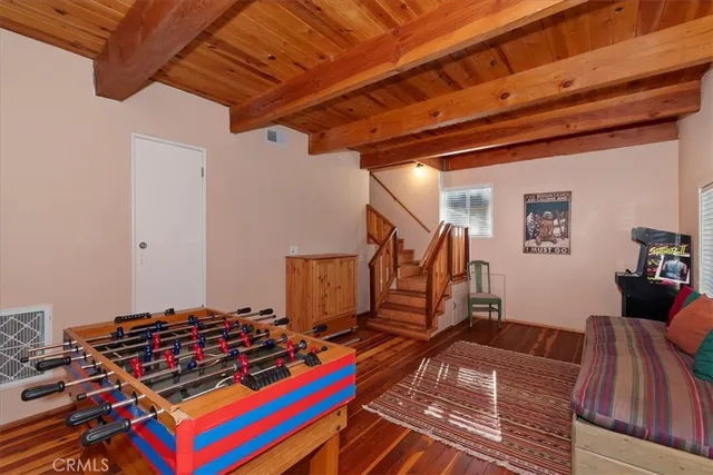 a view of gym equipment with wooden floor