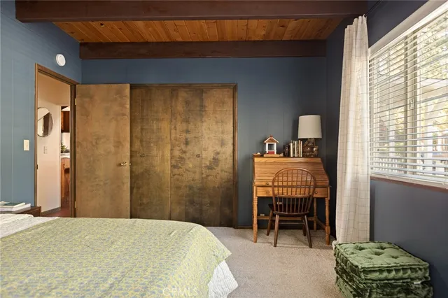 a bedroom with a bed and a chair in it