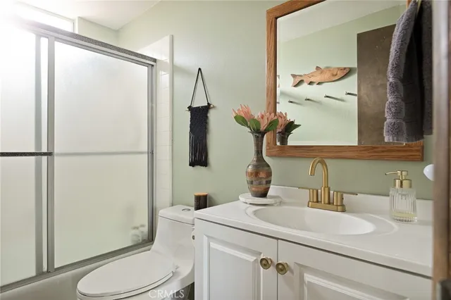 a bathroom with a sink a toilet and shower curtain