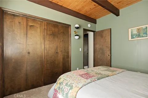 a bedroom with a bed and a mirror