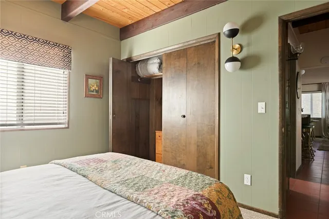 a bedroom with a bed and a shower