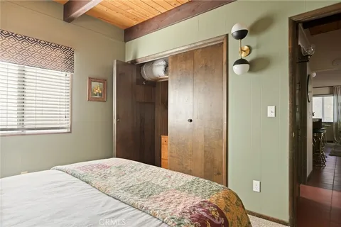 a bedroom with a bed and a shower