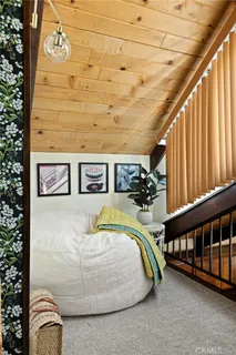 a bedroom with furniture and a large window