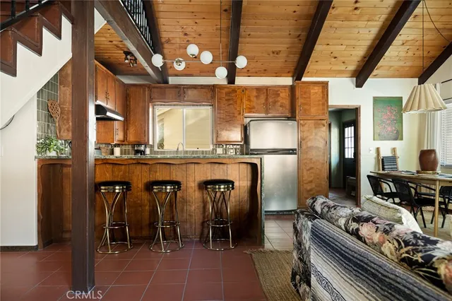 a kitchen with refrigerator and cabinets