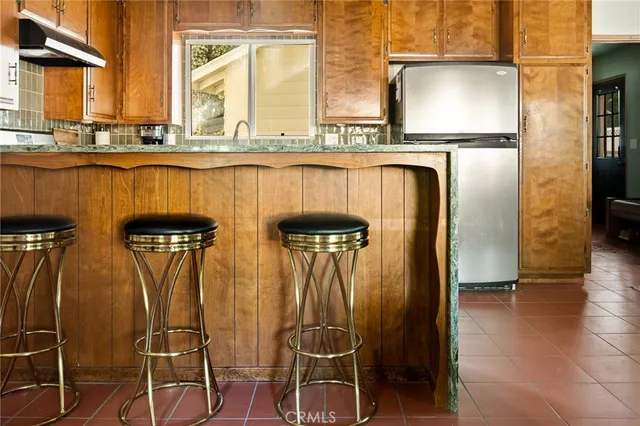 a kitchen with stainless steel appliances granite countertop a refrigerator and microwave