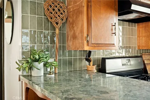 a bathroom with a granite countertop sink a mirror and shower