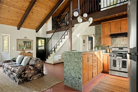 a living room with furniture wooden floor and a fireplace