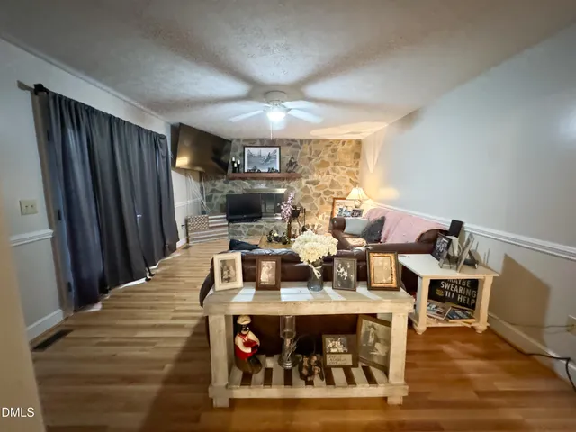 a dining room with furniture and wooden floor
