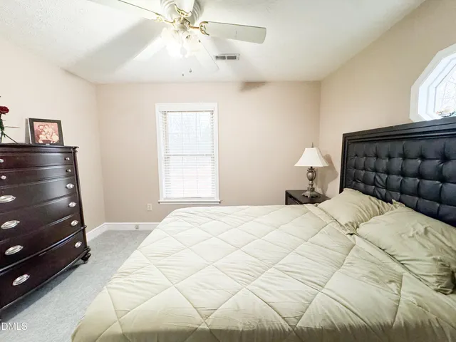 a bedroom with a bed and a lamp