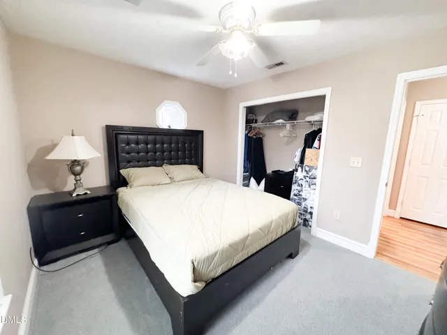 a bedroom with a bed and a closet