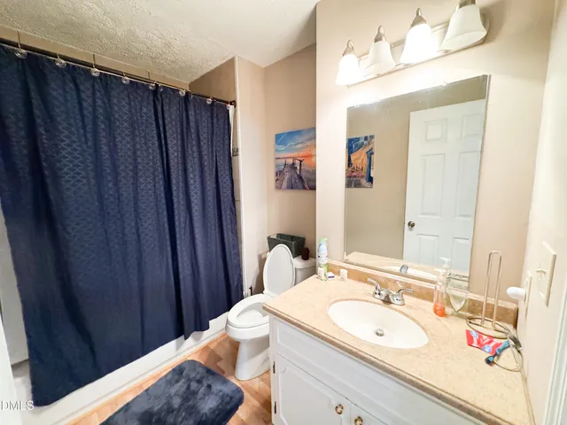 a bathroom with a sink vanity granite and a mirror