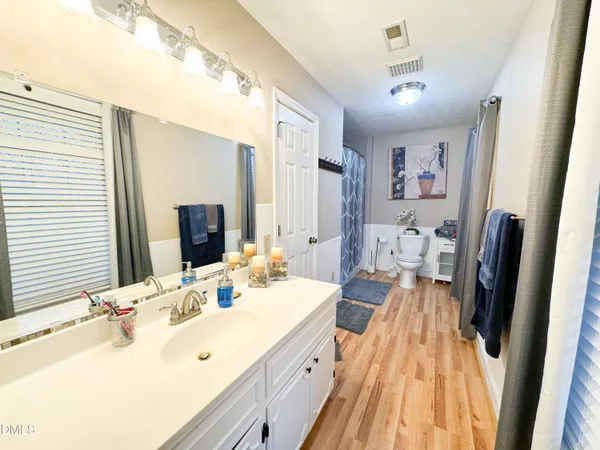 a spacious bathroom with a double vanity sink and a mirror