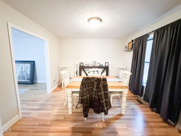 a room with wooden floor and furniture