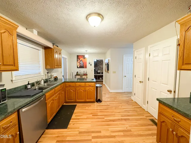 a large kitchen with kitchen island a sink stainless steel appliances and cabinets