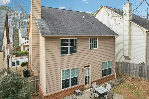 a view of a house with a chairs in patio
