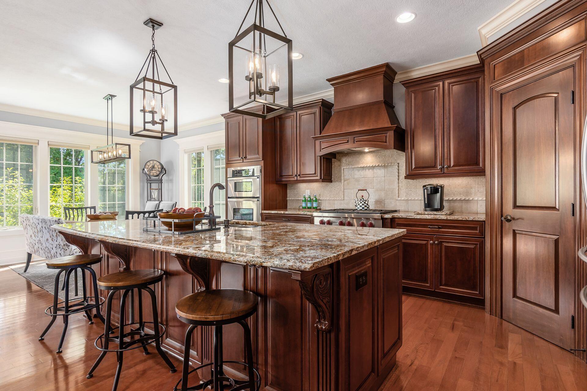 5475 Slater Ridge Westerville, OH 43082 - Photo 21 of 51 The kitchen boasts a sleek island bar that not only serves as a stylish focal point but also provides additional counter space and a casual dining area for family and guests.