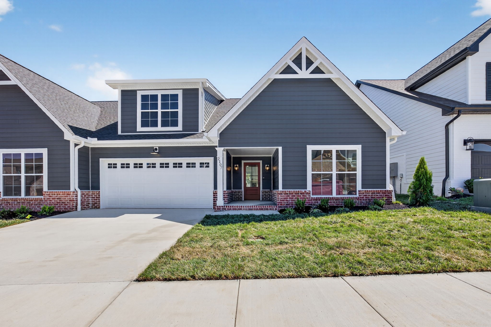 a front view of a house with a yard and outdoor seating