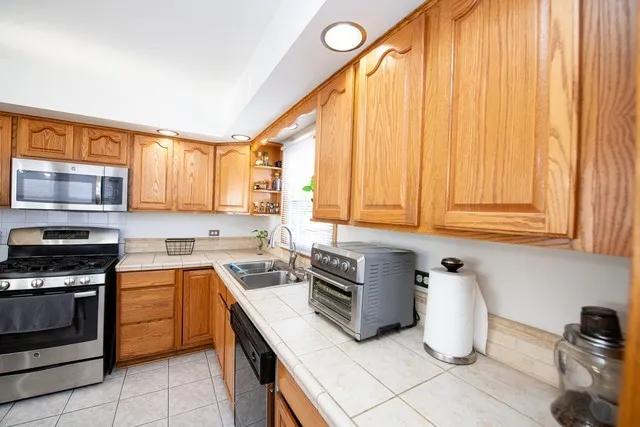a kitchen with a stove a sink and a microwave