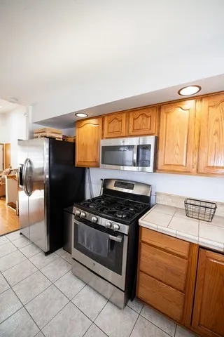a kitchen with stainless steel appliances granite countertop a stove and a refrigerator