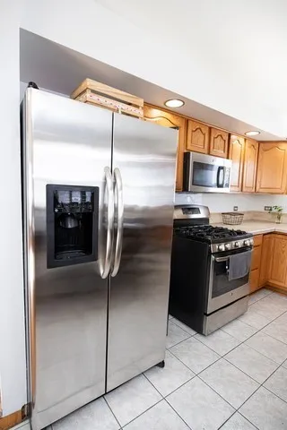 a kitchen with stainless steel appliances granite countertop a stove and a refrigerator