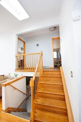 a view of entryway and hall with wooden floor