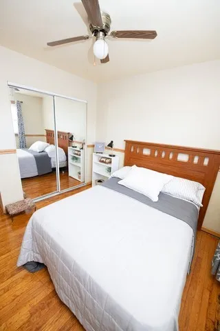 a bed room with a bed and a chair