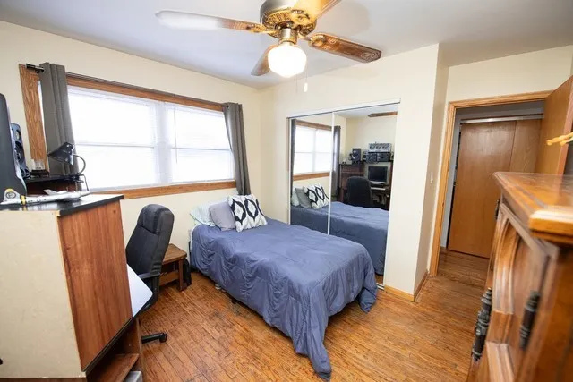 a bedroom with a bed and a large window