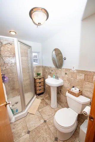 a bathroom with a toilet sink and mirror