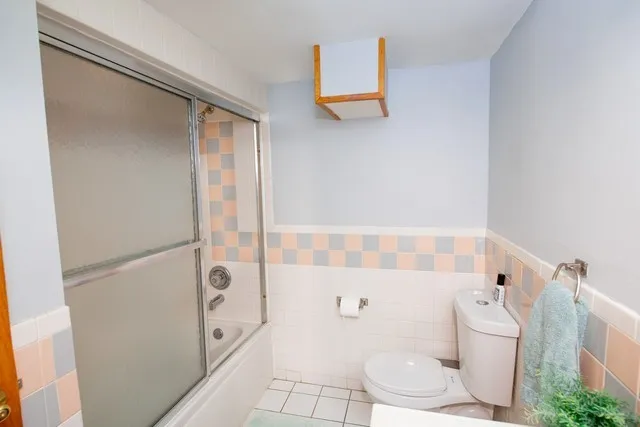a bathroom with a toilet and a shower