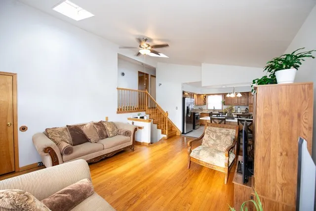 a living room with furniture and a chandelier