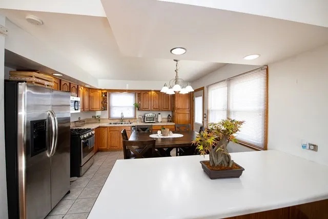 a kitchen with refrigerator and window