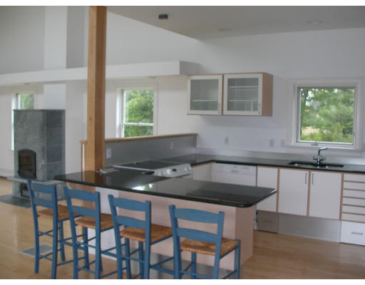 481 Hill Road Boxborough, MA 01719 - Photo 3 of 13 a kitchen with a table chairs wooden cabinets and a window