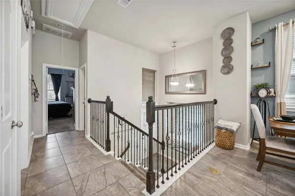 a view of a hallway to a livingroom with furniture and windows