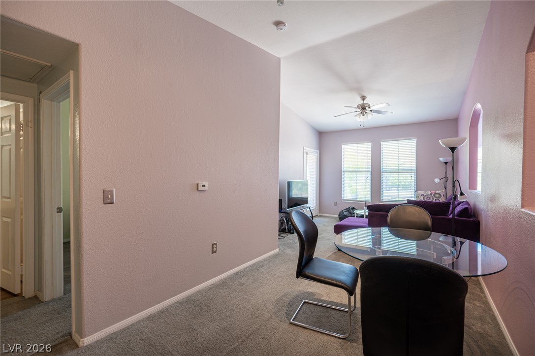 10550 West Alexander Road, Unit 2014 Las Vegas, NV 89129 - Photo 2 of 35 This airy living and dining area boasts vaulted ceilings and soft carpet underfoot, creating an inviting atmosphere.