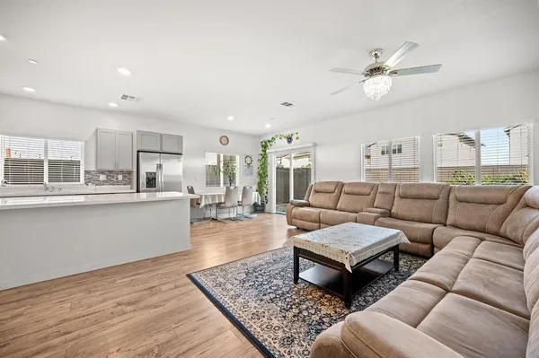 a living room with furniture and kitchen view