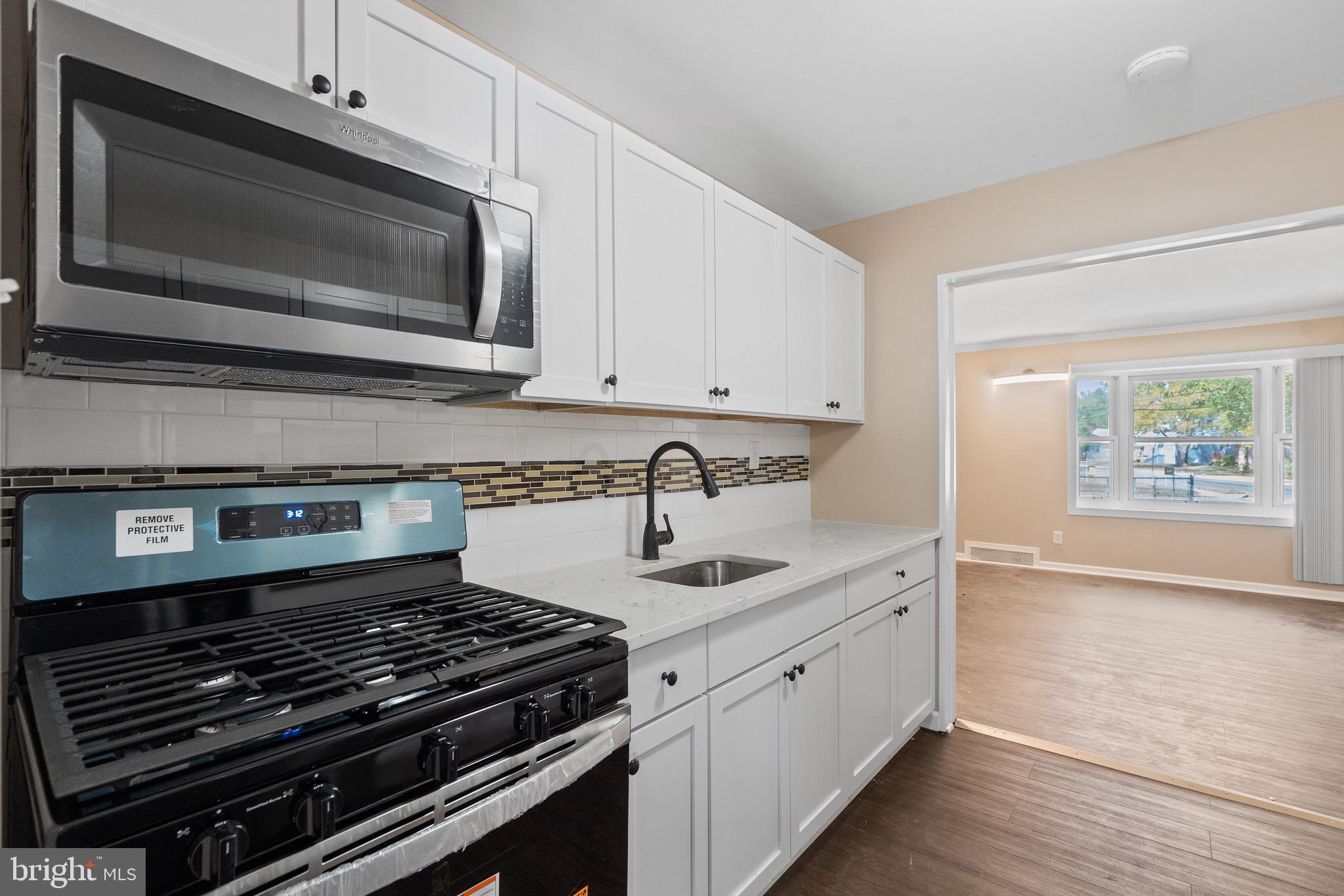 4 West Germantown Avenue Maple Shade, NJ 08052 - Photo 4 of 29 a kitchen with stainless steel appliances a stove a microwave and cabinets