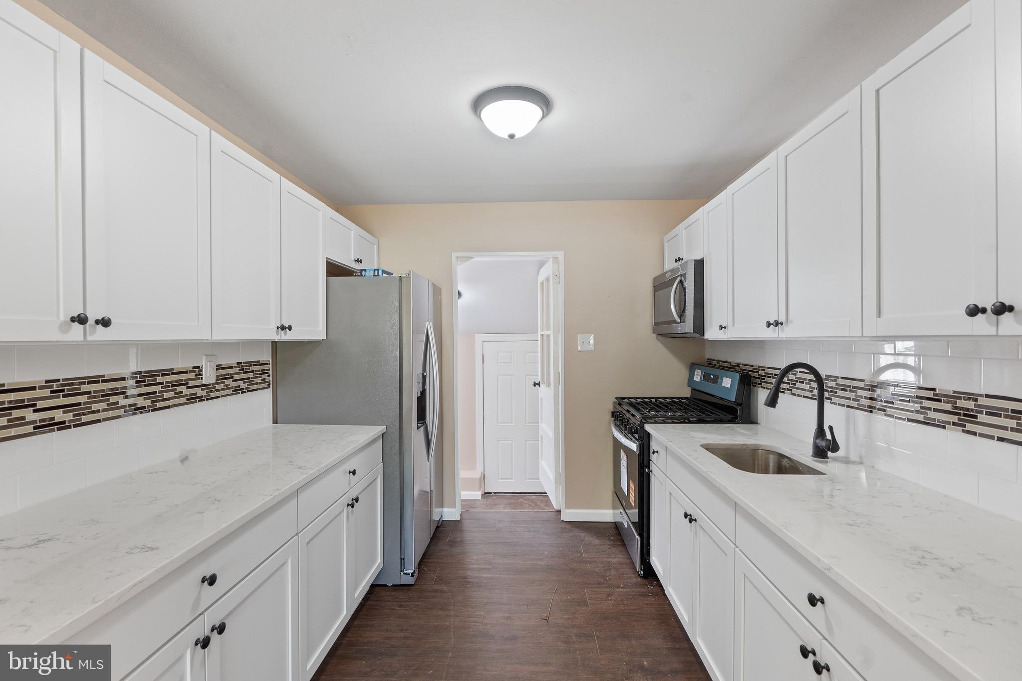 4 West Germantown Avenue Maple Shade, NJ 08052 - Photo 5 of 29 a kitchen with granite countertop a sink a stove and refrigerator