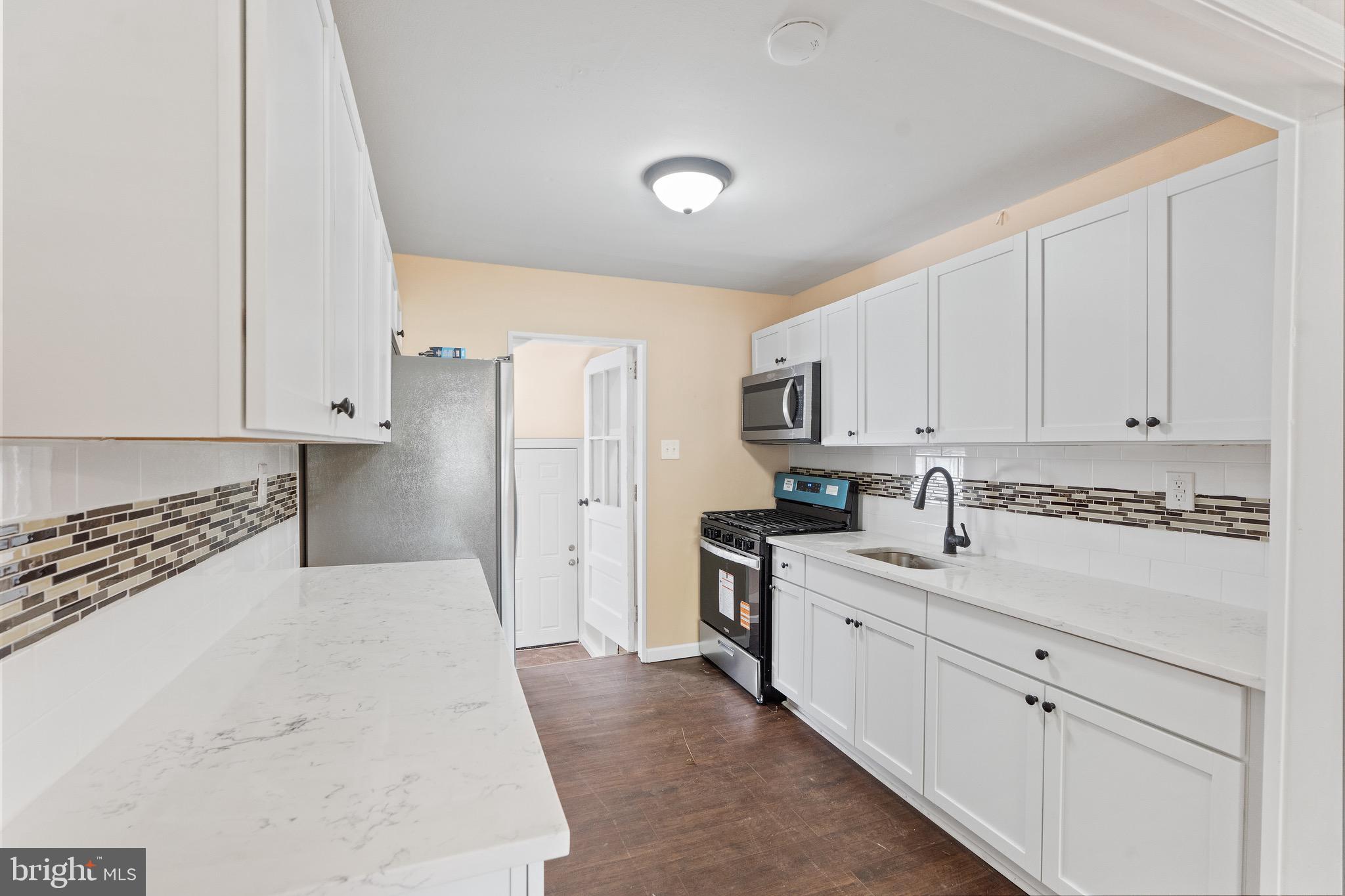 4 West Germantown Avenue Maple Shade, NJ 08052 - Photo 7 of 29 a kitchen with stainless steel appliances a sink stove and cabinets