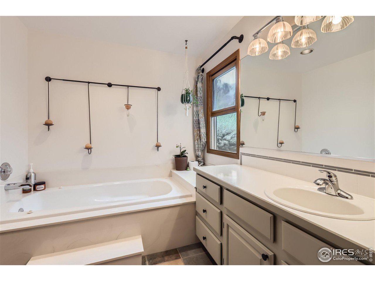 6301 Victoria Road Fort Collins, CO 80525 - Photo 11 of 16 a bathroom with a tub sink and mirror