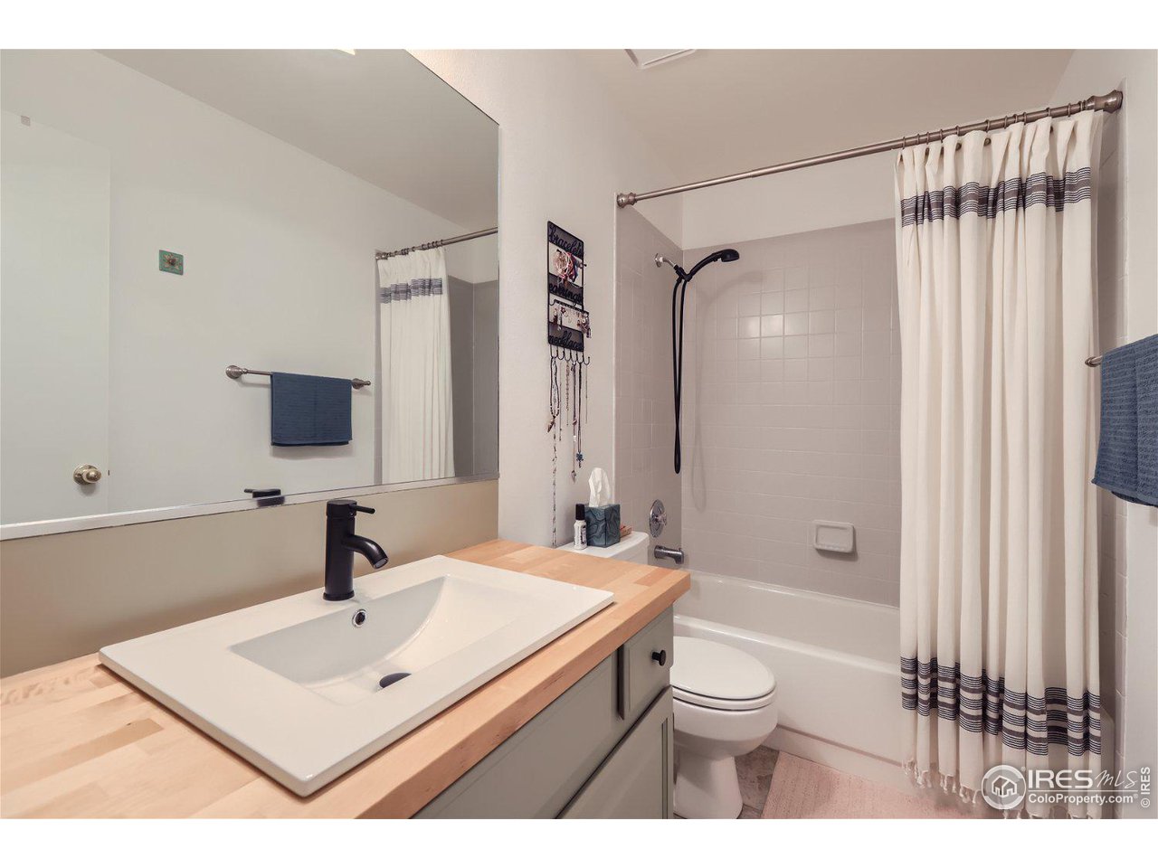 6301 Victoria Road Fort Collins, CO 80525 - Photo 12 of 16 a bathroom with a sink toilet a shower and a mirror