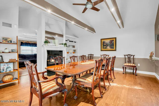 a dining room with furniture potted plants and a fireplace