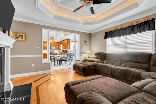 a kitchen with stainless steel appliances kitchen island granite countertop a stove a sink a dining table and chairs with the cabinets