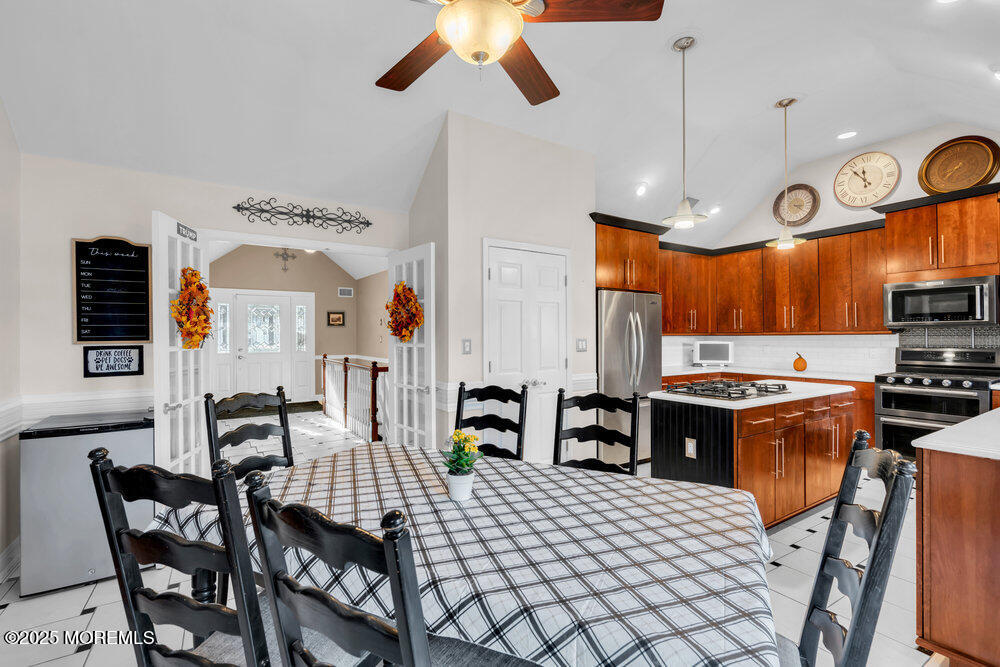 117 South Cooks Bridge Road Jackson, NJ 08527 - Photo 18 of 48 a kitchen with stainless steel appliances kitchen island granite countertop a stove a sink a dining table and chairs with the cabinets