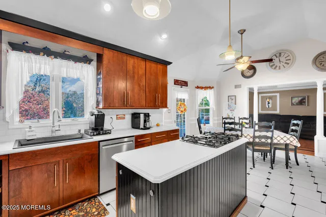 a kitchen with wooden cabinets stainless steel appliances and a refrigerator