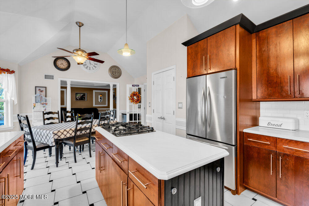 117 South Cooks Bridge Road Jackson, NJ 08527 - Photo 22 of 48 a kitchen with stainless steel appliances granite countertop a stove a refrigerator a oven a kitchen island a dining table and chairs with wooden floor